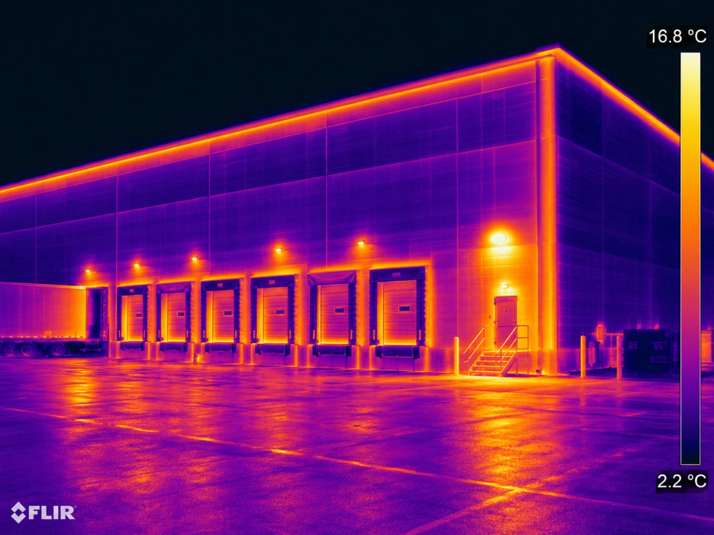 Infrared image of a commercial loading dock elevation showing heat loss around overhead doors and dock seals
